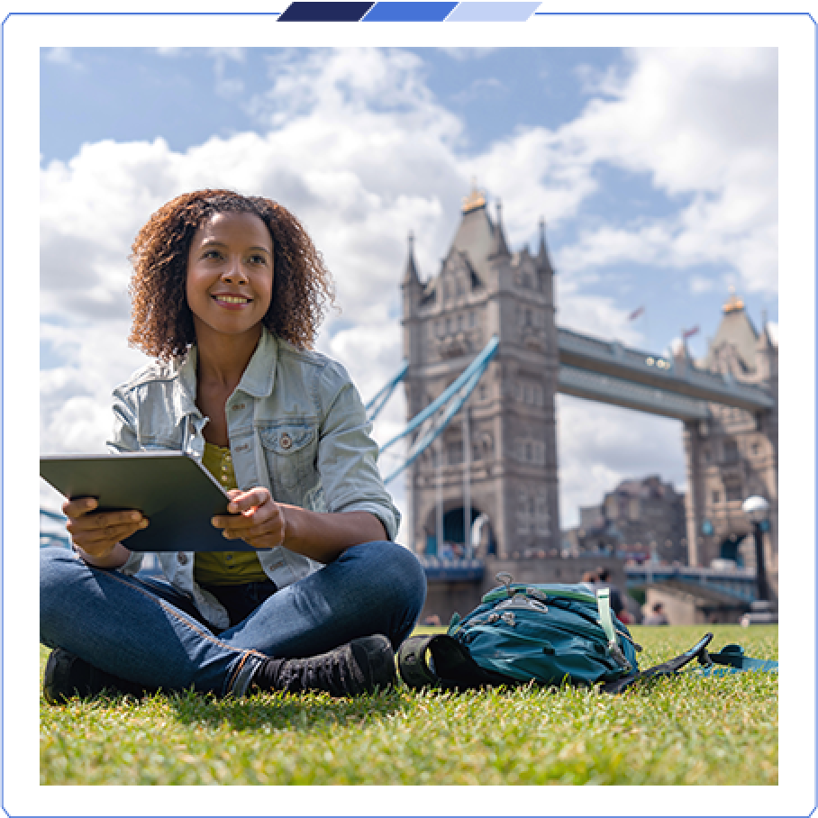 Market Extension A customer sat on a field holding an iPad with the London Bridge in the background